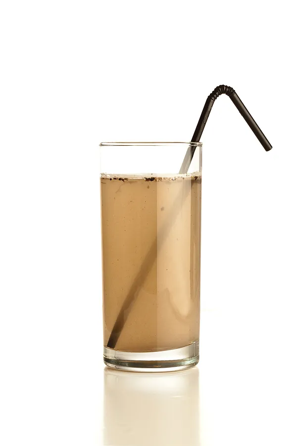 Glass of murky brown water with a straw
